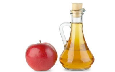 Decanter with vinegar and red apple